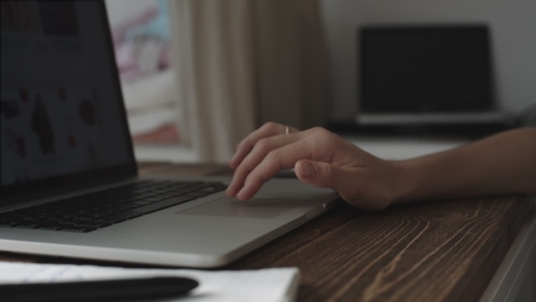 Woman Working With Laptop Placed On Wooden Desk