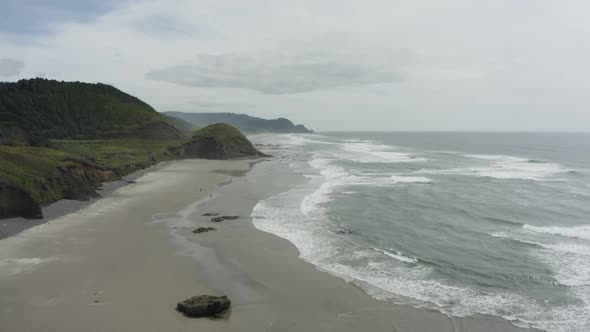 Wide tracking drone shot of expansive beach