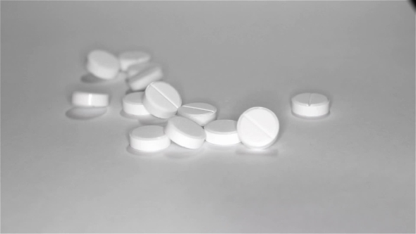 White Pills Scattered On The Table