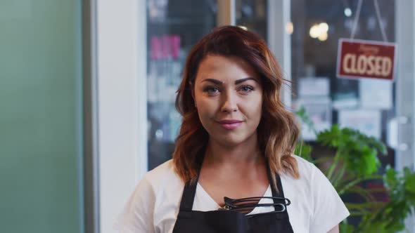 Portrait of Female hairdresser smiling at hair salon