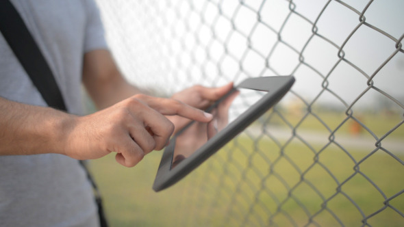 Busy Using Tablet in Open Air