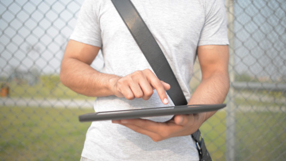 Casual Man Typing Text Message Tablet in Open Air