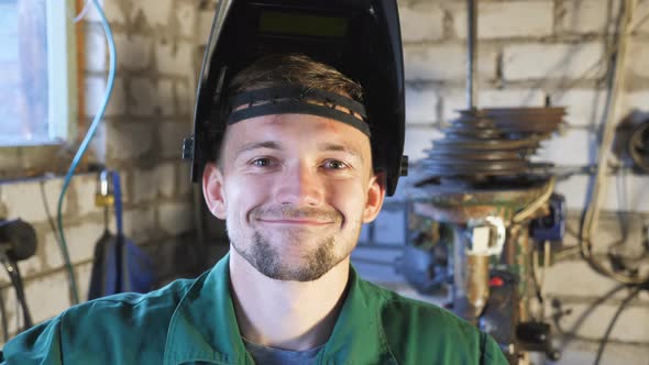 Portrait of Mechanic in Uniform Making Funny Face and Fooling Around Into Camera