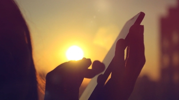 Woman Using Smart Phone Of City With Blurred