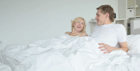 Couple lying in bed and chatting