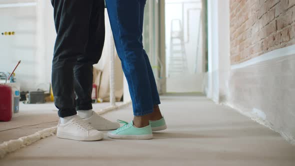 Close Up of Male and Female Legs Over Renovating House Background