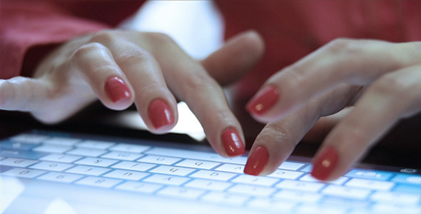 Woman Hands Typing On The Tablet
