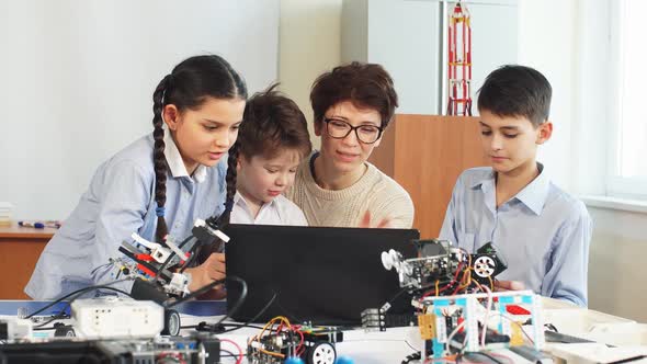 Happy Children Learn Programming Using Laptops on Extracurricular Classes