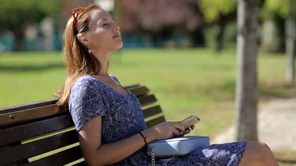 Young Woman Dislike Reading a Book And Sitting On