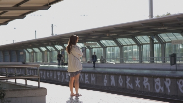 Young Woman Waiting For a Train At Platform 