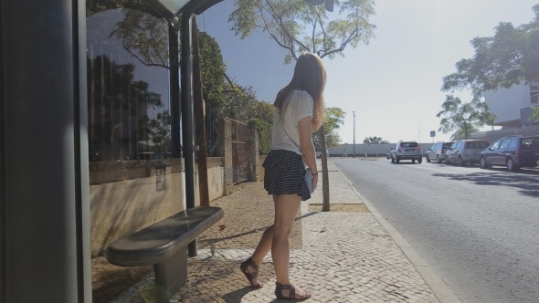 Lonely Young Girl Waiting Staying At Bus Stop In