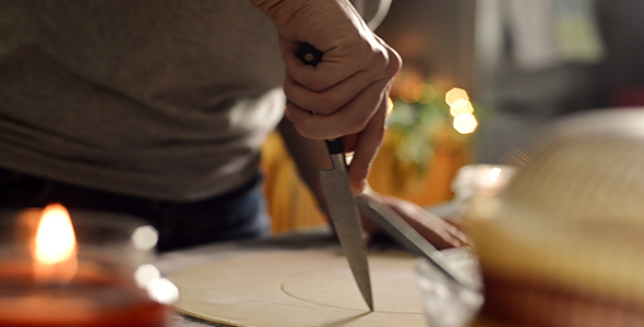 Woman Uses Knife to Cut a Circle of Marzipan