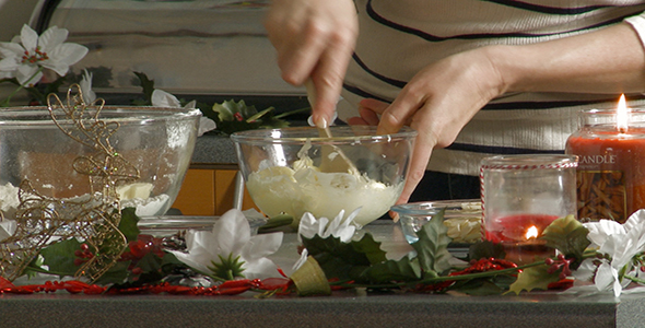 Woman Creams Butter in a Large Glass Bowl