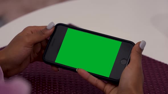 Female Black Hands Uses Smartphone with Green Screen Chroma Key