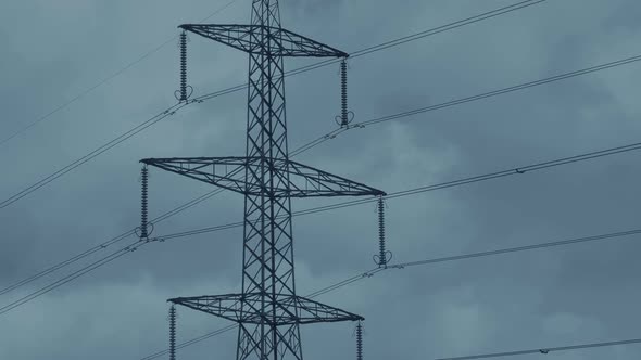 Power Lines And Tower With Clouds Moving Behind