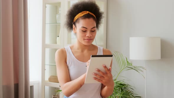 African american woman pensively thinks and making notes in paper notebook. Writing idea