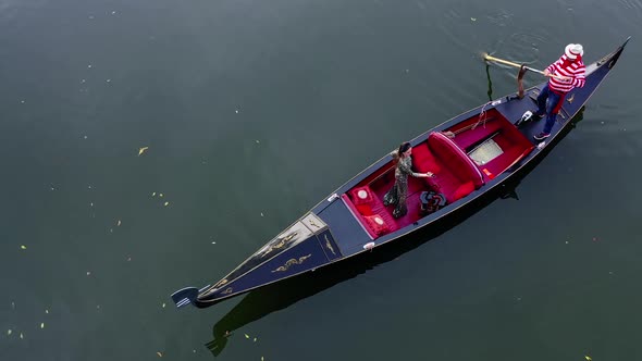 Luxury woman travels in gondola. Italian gondola floating on the blue river background.