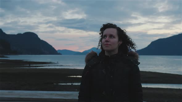 Adventurous Adult Woman Taking in the View of Pacific Ocean Coast