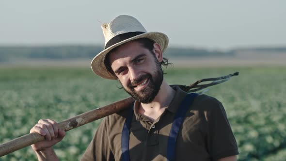 Portrait of Smiling Farmer with Pitchfork