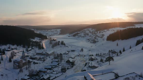 Aerial View of the Village at Sunset in Winter with Bright Sun