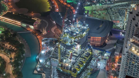 Under Construction Highrise Building with Yellow Construction Crane in Dubai Night Timelapse