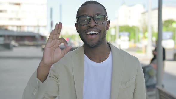 African Man Showing Ok Sign with Finger Outdoor