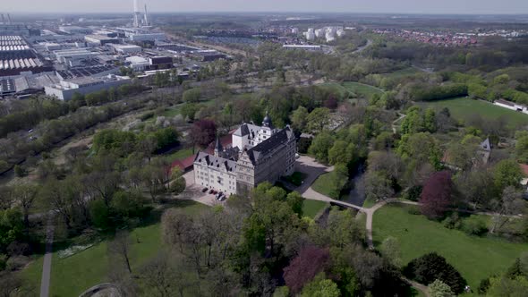 Schloss Wolfsburg castle and surrounding gardens, rotating aerial shot