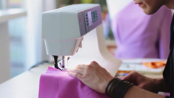 Fashion Designer with Sewing Machine Working