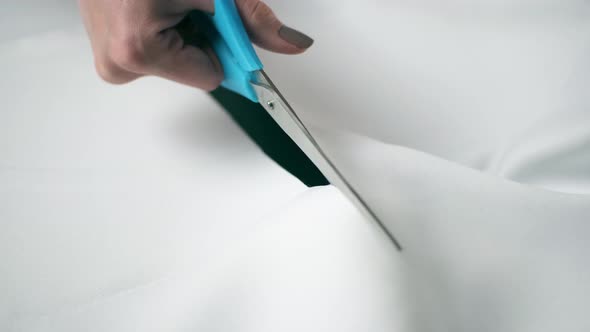 A Dressmaker Cutting a High Quality Fabric White