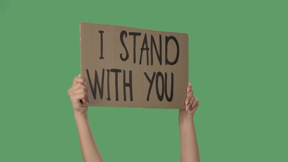 Showing Cardboard Poster with Inscription I STAND WITH YOU. Human Rights Demonstration. Hands