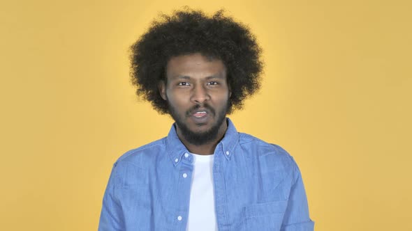 AfroAmerican Man Shaking Head to Reject on Yellow Background