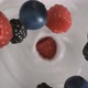 Fresh red-black raspberries and blueberries rain on yogurt in slow motion - High-angle shot - VideoHive Item for Sale