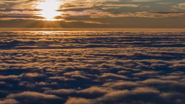 Timelapse of the sunset over clouds.