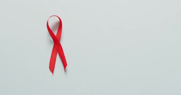 Video of red blood cancer ribbon on pale blue background