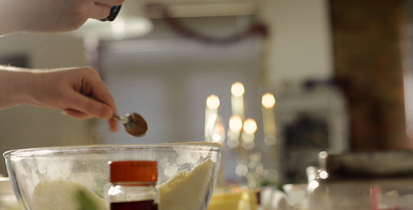 Woman Stirs a Teaspoon of Spice into Flour