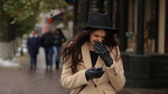 The Girl In Beige Coat Walks Around 