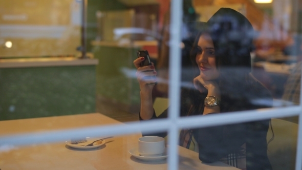 Beautiful Woman Sitting In Cafe At The Window