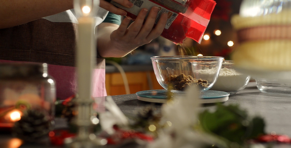 Woman Measures Brown Sugar into a Glass Bowl