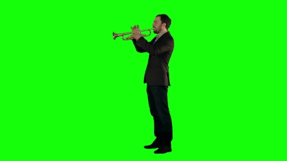 Man Standing And Trumpet Melody. On a Green Screen