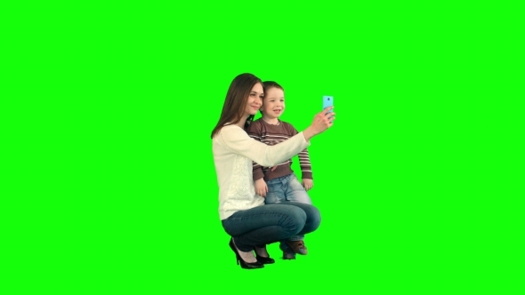 Mother And Son Posing For Selfie  On a Green