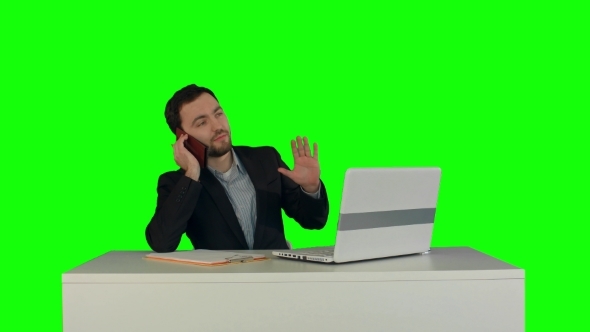 Young Business Man Speaking On The Phone In Office
