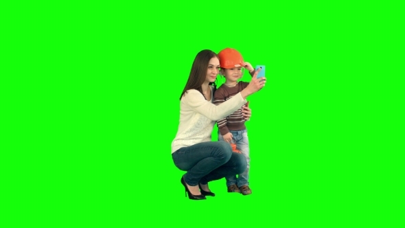 Boy Taking a Selfie With Her Mother On a Green