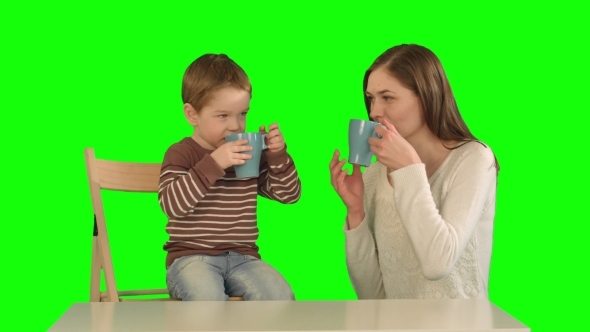 Son With His Mother Drinking Tea On a Green Screen