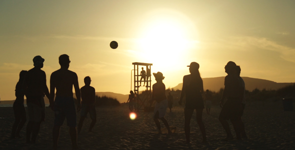 Young People Playing Beach Ball at Sunset