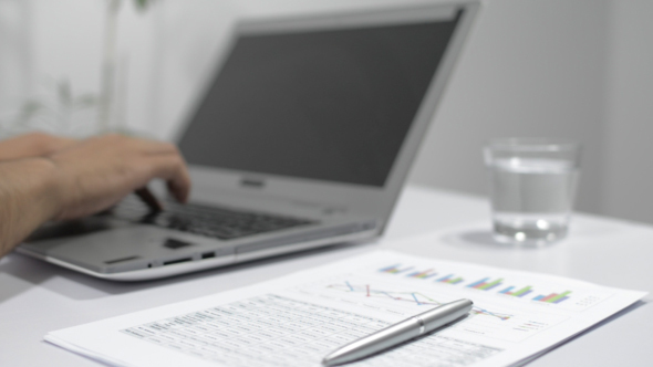 Man Working in Office, Working on Laptop alt