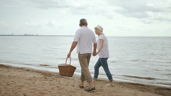 Senior Lovers Meeting Day on Beach, Walking and Takling on Shoreline After Picnic