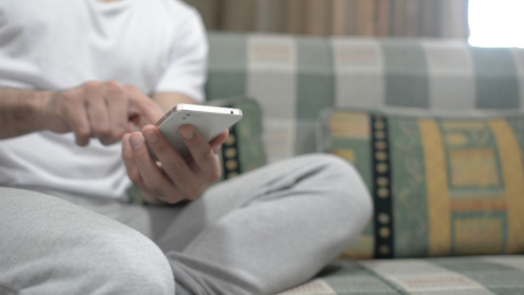 Using Smartphone, Sitting on Sofa