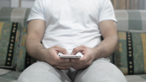 Casual Man Typing on smartphone alt