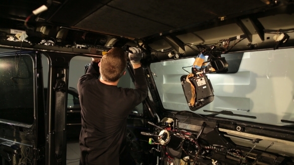 Man Engaged In Sound Insulation Of The Roof Of The