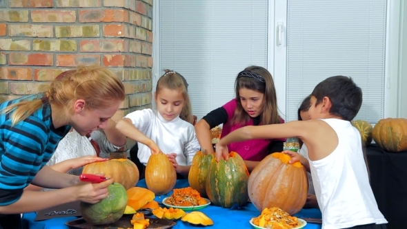 Children And Adults Cleaning Halloween Pumpkins